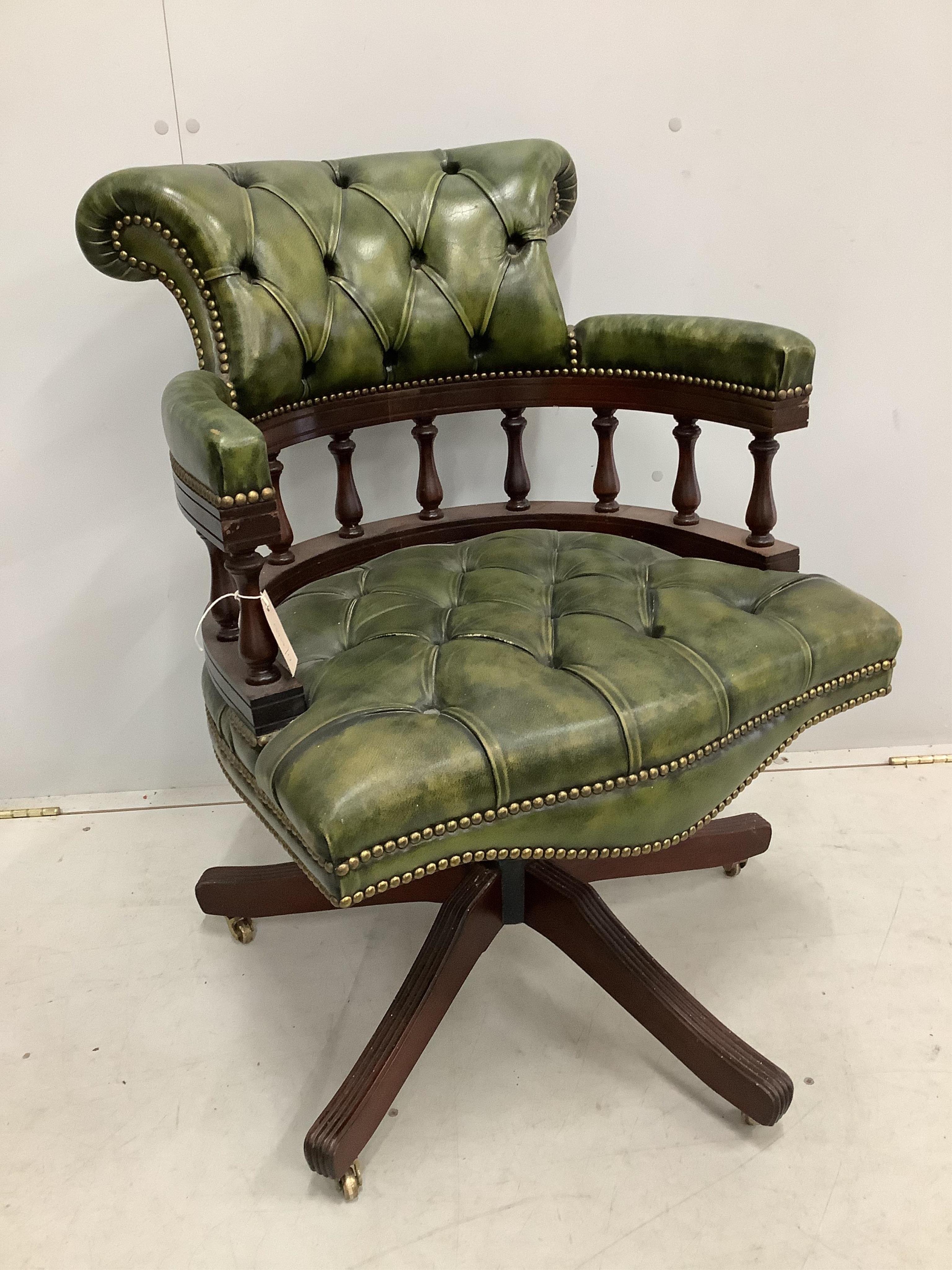 A reproduction Victorian style buttoned green leather swivel desk chair, width 63cm, depth 56cm, height 88cm
